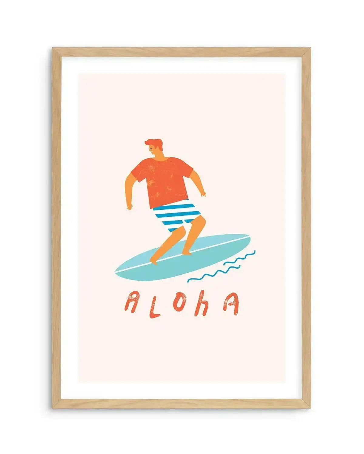 Art print featuring a stylized illustration of a surfer on a light blue surfboard, riding a small wave. The surfer is a man with orange skin, wearing an orange t-shirt and blue and white striped swim shorts. The word "ALOHA" is written in orange, blocky letters below the surfboard. The artwork has a slightly textured, hand-drawn quality and is displayed in a natural oak frame with a white border.
