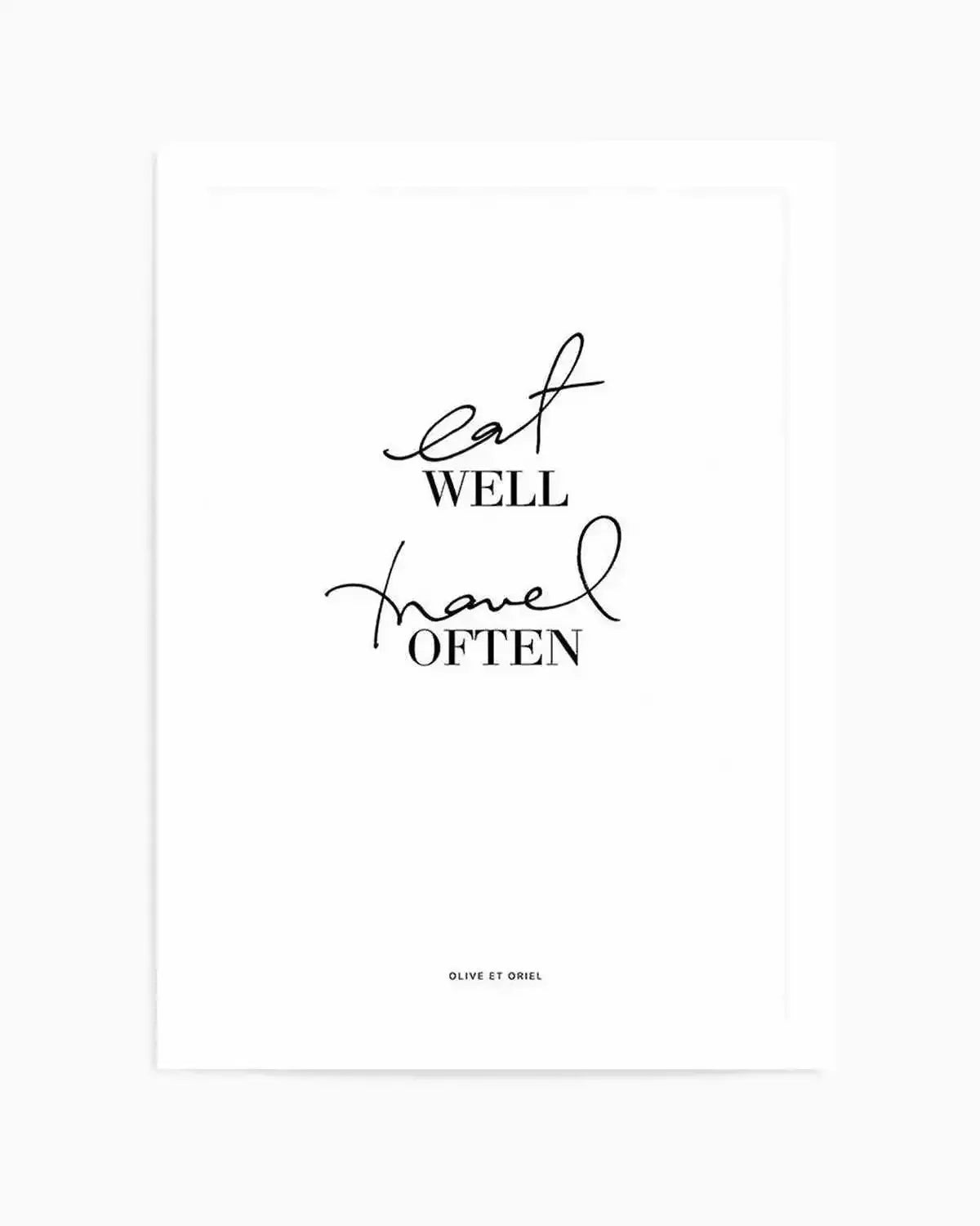 White art print featuring hand-lettered text in black ink on a light cream background. The design reads "eat well" in flowing script at the top, followed by "travel often" in matching cursive script below, with "WELL" and "OFTEN" in clean sans-serif capitals. The composition is centered and minimalist with generous white space. Small text reading "OLIVE ET ORIEL" appears at the bottom. The print has a matte finish and clean white border, suitable for framing.