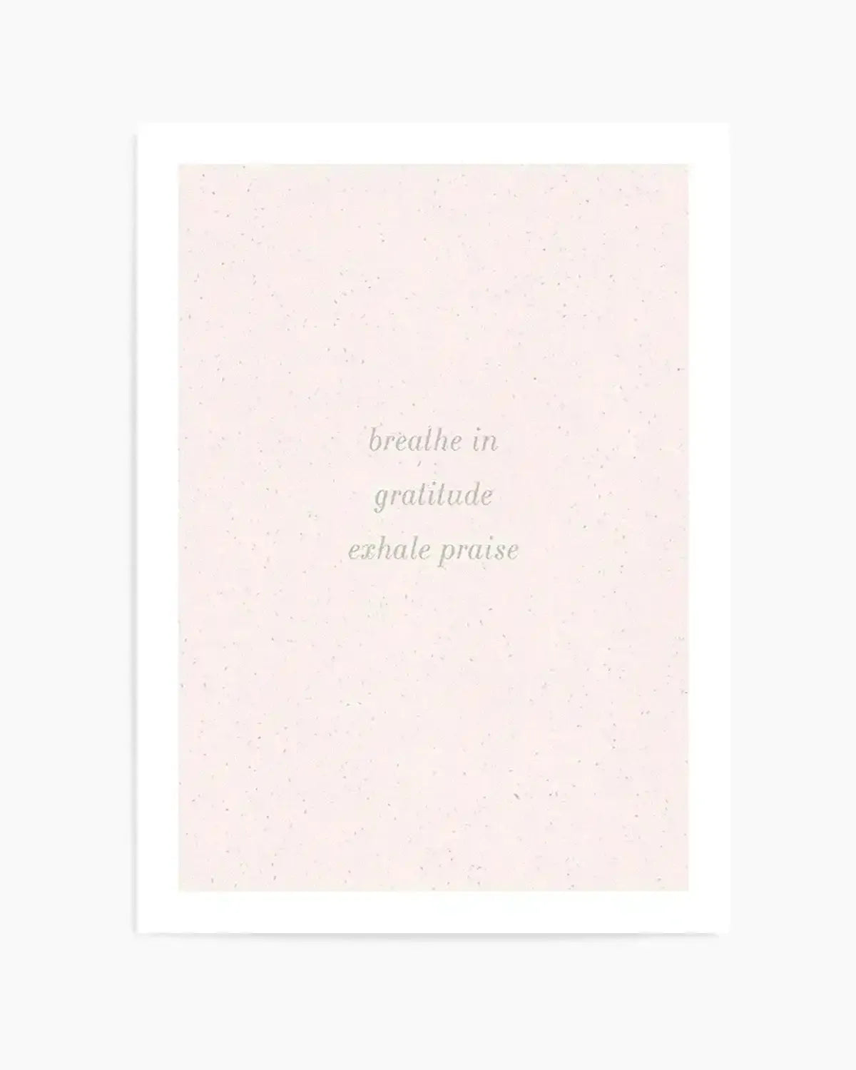 Art print featuring the words "breathe in gratitude exhale praise" in a delicate, light green script on a soft, speckled blush pink background.
