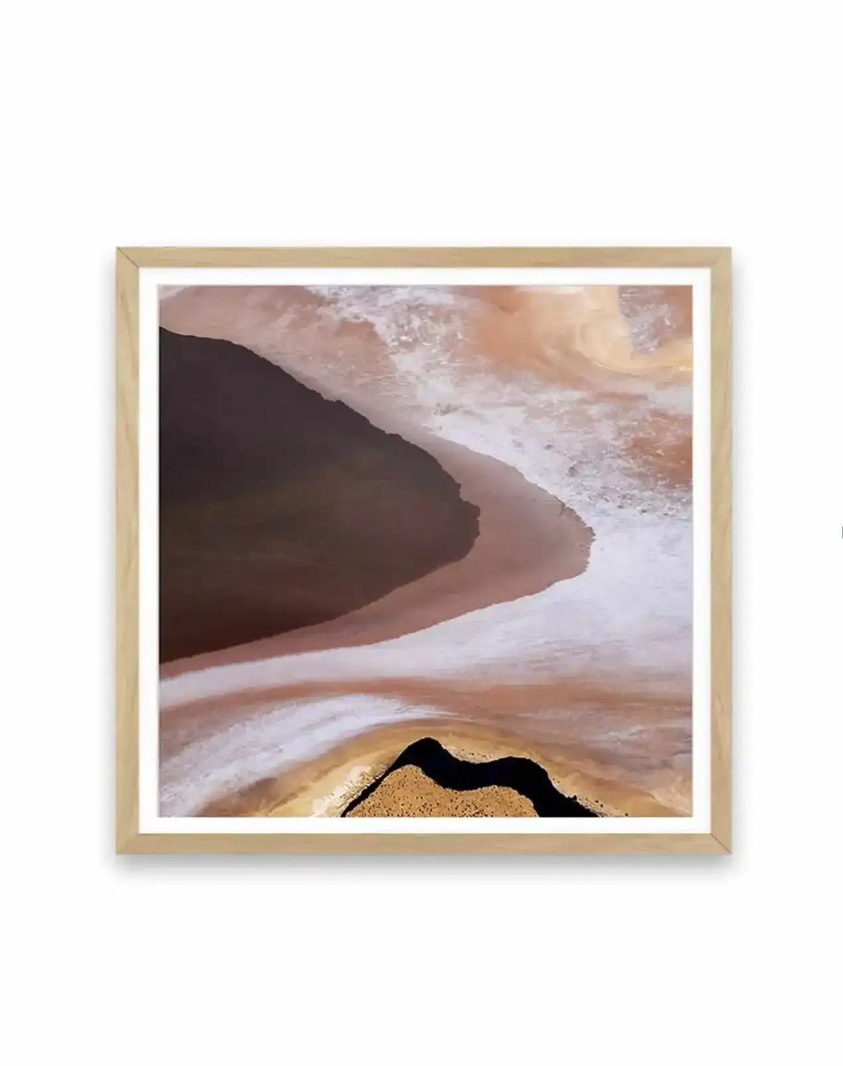 Abstract:
Abstract art print featuring an aerial view of a landscape with a dark, deep brown body of water on the left, curving into a lighter, sandy brown and white shoreline. The right side of the print shows swirling patterns of light brown, white, and pale orange, suggesting salt flats or desert terrain. A thin, dark, winding river or channel cuts through a textured, golden-brown landmass at the bottom, all displayed in a natural oak frame with a white border.