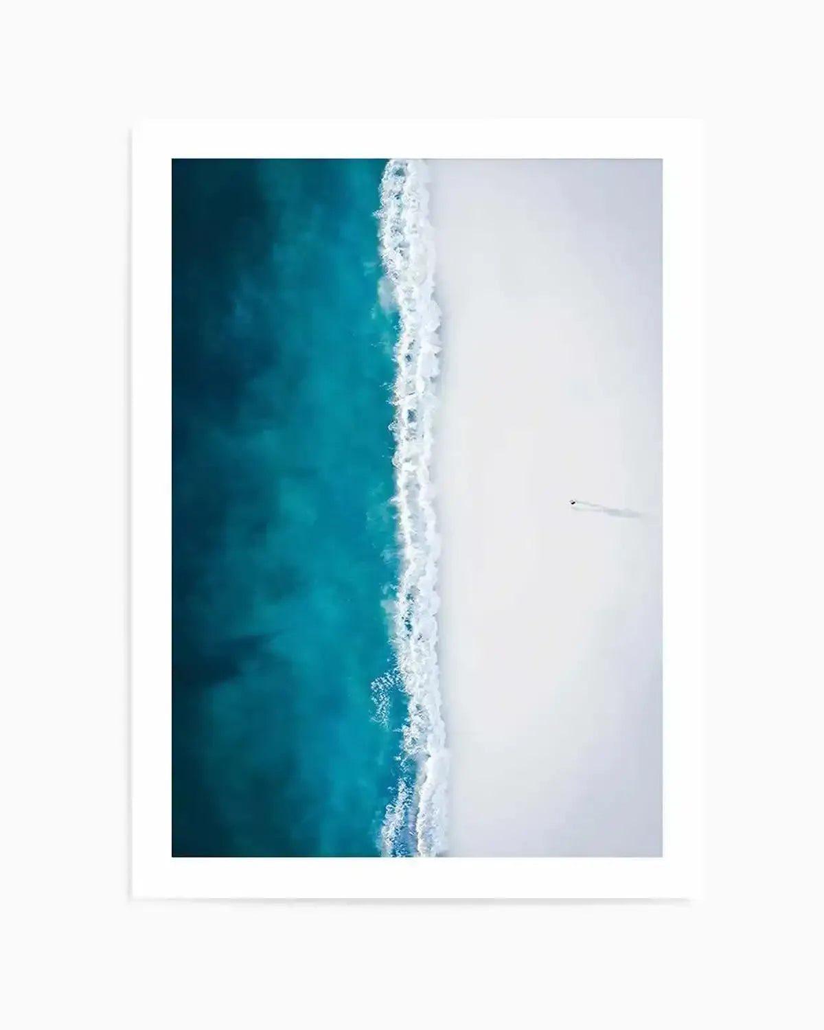 Aerial coastal photo of teal ocean and white sandy beach with lone figure, unframed with white border