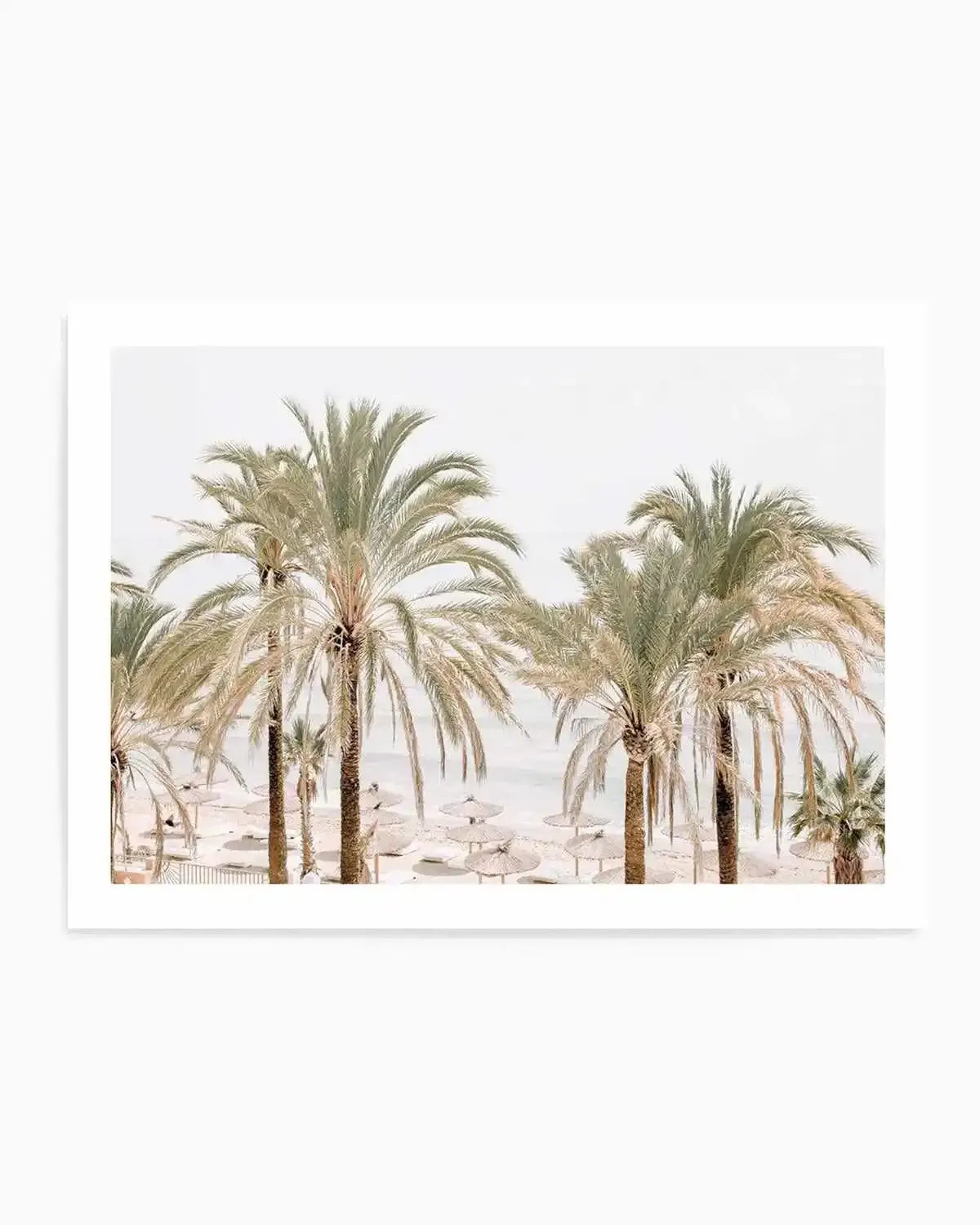 Art print featuring a serene beach scene with several tall palm trees in the foreground, their fronds a mix of pale green and sun-kissed beige, against a soft white sky. The sandy beach below is dotted with numerous light-coloured straw beach umbrellas, with the calm, light blue ocean visible in the background.