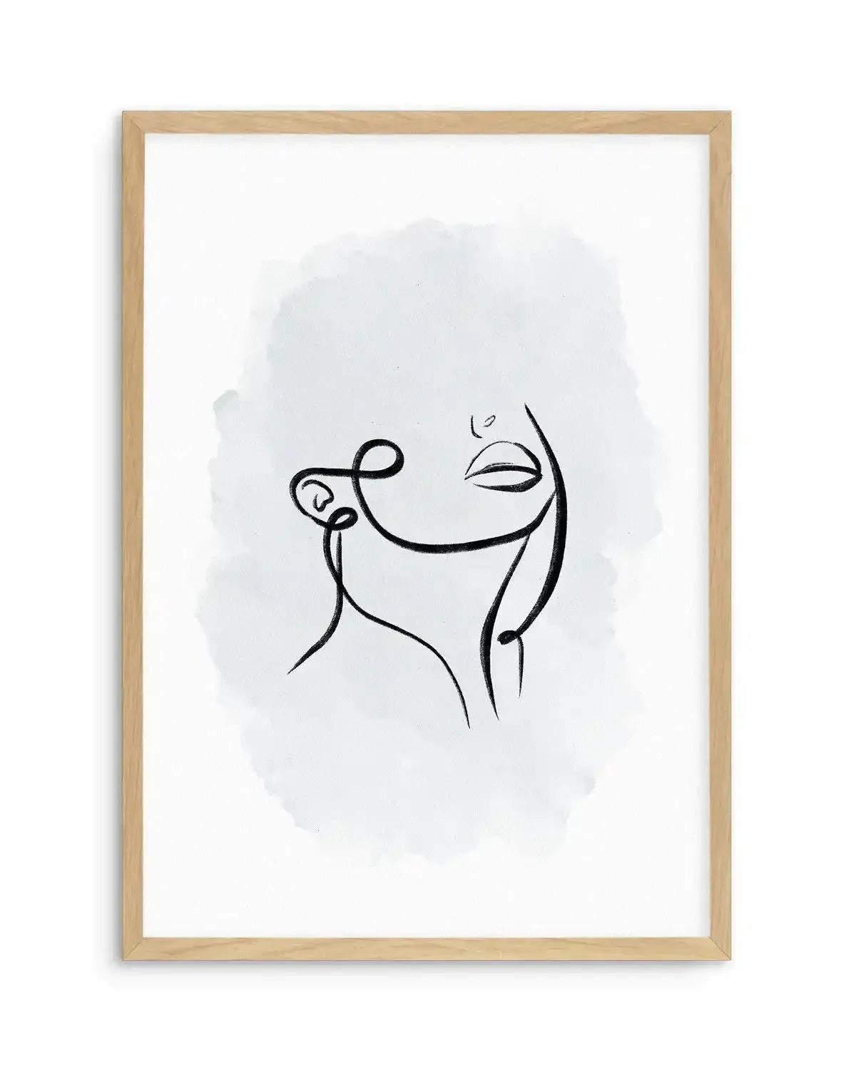 Framed art print featuring a minimalist line drawing of an abstract face in profile, rendered with continuous black ink lines on a white background. A soft, diffused periwinkle blue watercolor wash creates a subtle rounded background shape behind the figure. The drawing shows simplified facial features with closed or downturned eyes and a curved smile. Natural wood frame with white border. Vertical composition on white paper.