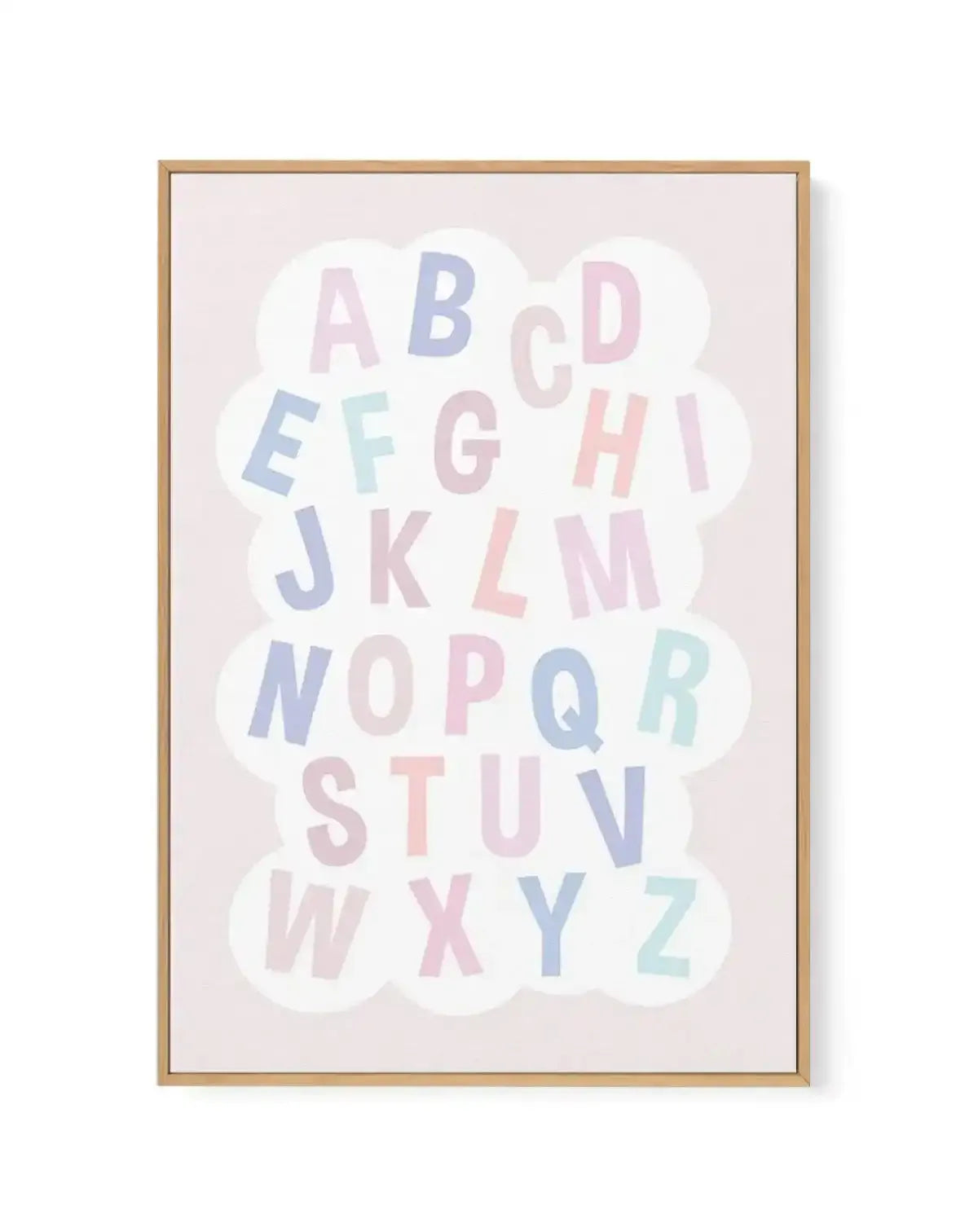 Framed canvas art print featuring the complete alphabet arranged in a cloud shape against a soft beige background. Letters in pastel colors including dusty blue, blush pink, sage green, and pale mauve are scattered throughout the design. Natural wood frame with white border.