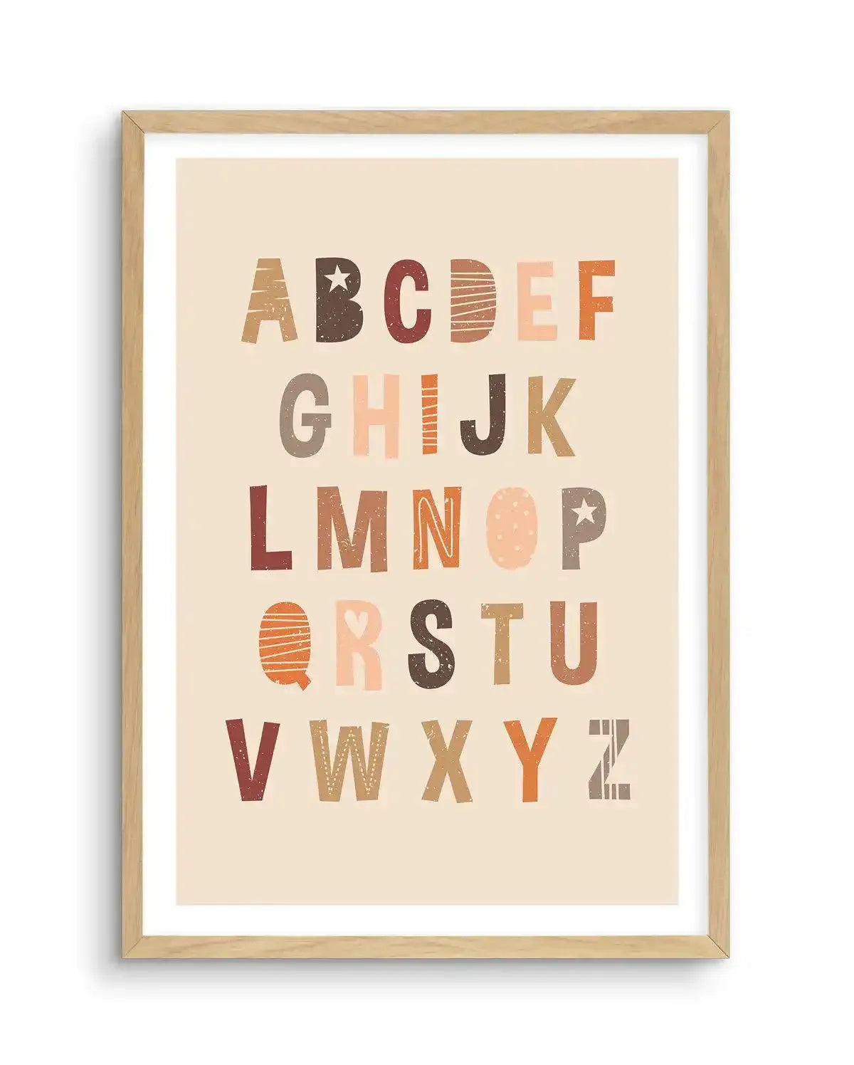 Art print featuring the uppercase alphabet in a playful, distressed font with various patterns and textures, printed on fine art paper and displayed in a natural oak frame with white border. The letters are arranged in rows, with colours including dark brown, peach, terracotta, and cream.