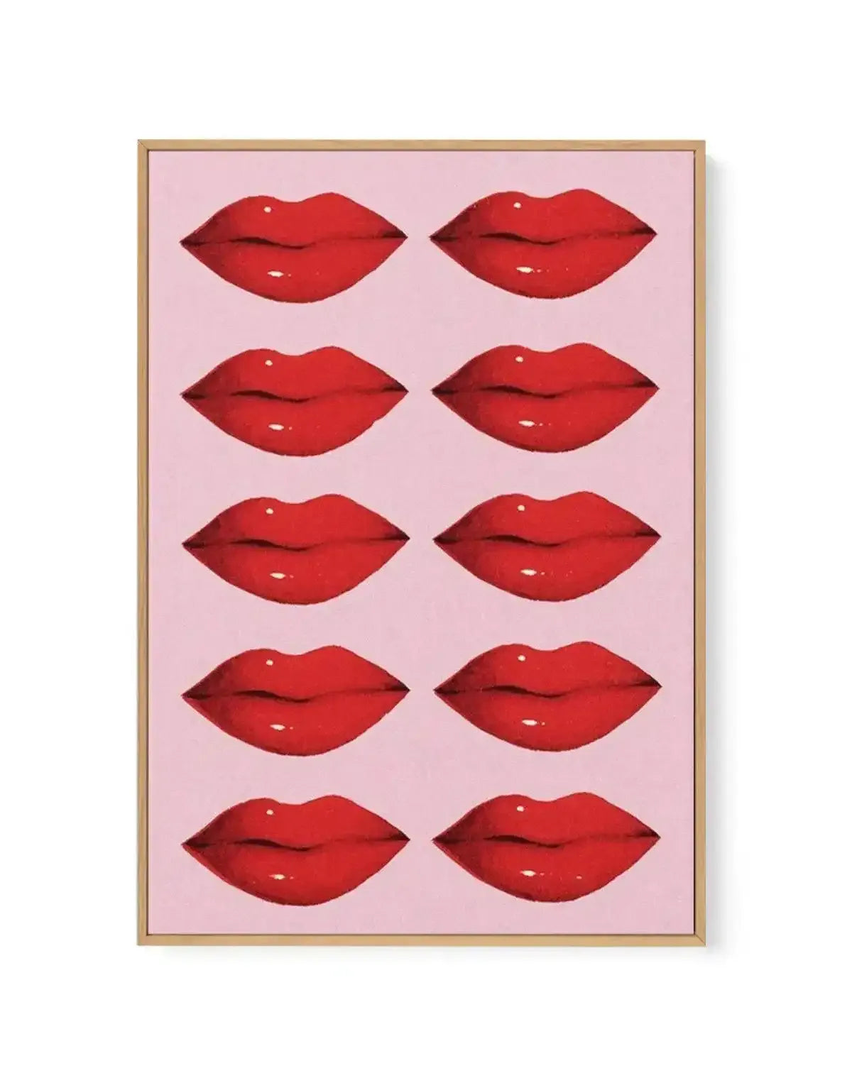Framed canvas art print featuring a grid of ten identical red lips arranged in five rows of two against a soft pink background. Each lip illustration is rendered in glossy, deep red with subtle white highlights and dark shadowing to create dimension. The canvas is surrounded by a natural wood frame with a white border. The overall composition has a pop art aesthetic with a romantic, beauty-focused theme.