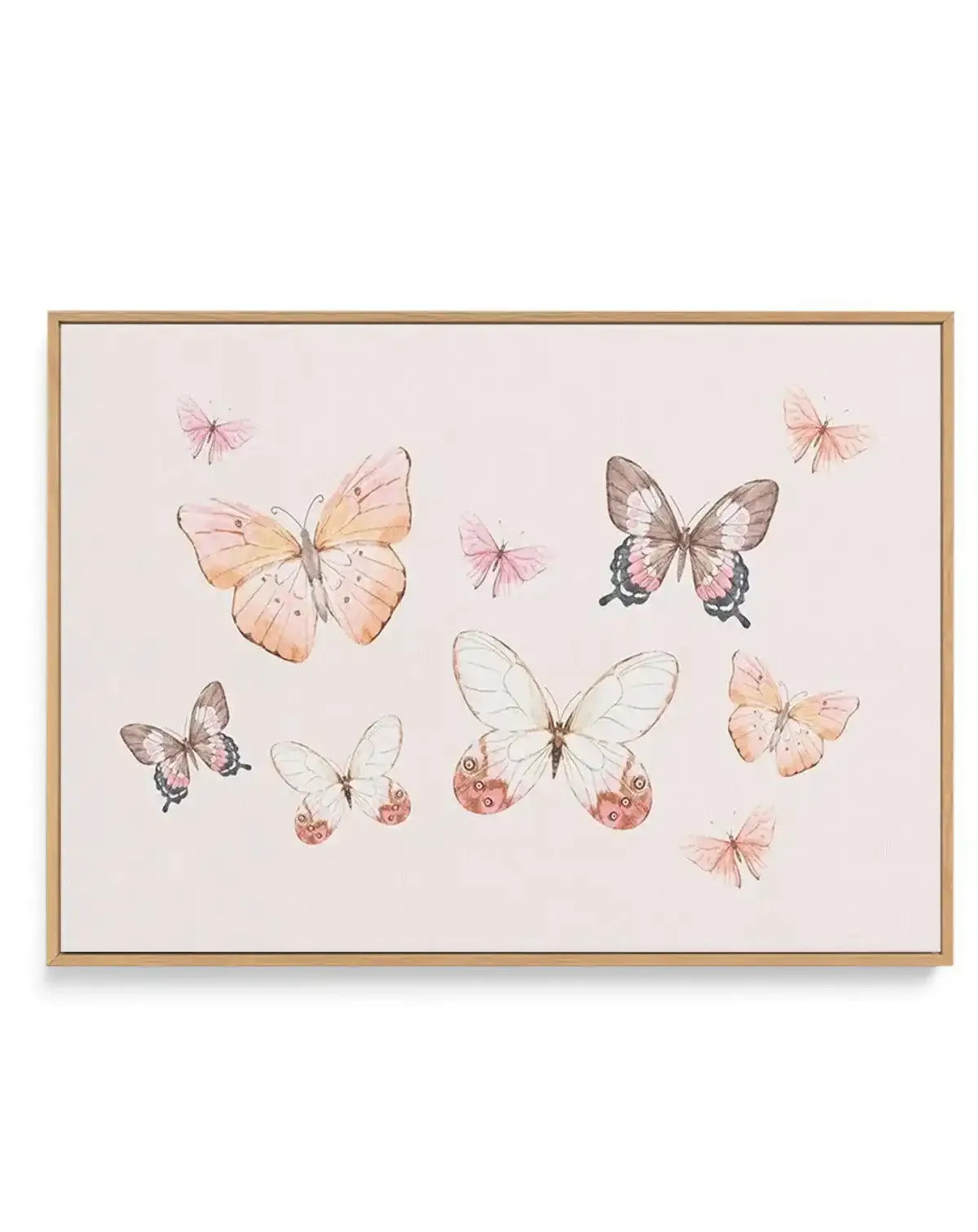 Framed canvas art print featuring a delicate watercolor illustration of various butterflies in shades of blush pink, peach, cream, and taupe scattered across a soft beige background. The composition includes larger detailed butterflies with spotted wing patterns alongside smaller, more minimalist butterfly designs. The canvas is set in a natural wood frame with a white border, creating a soft, bohemian aesthetic against the pale neutral palette.