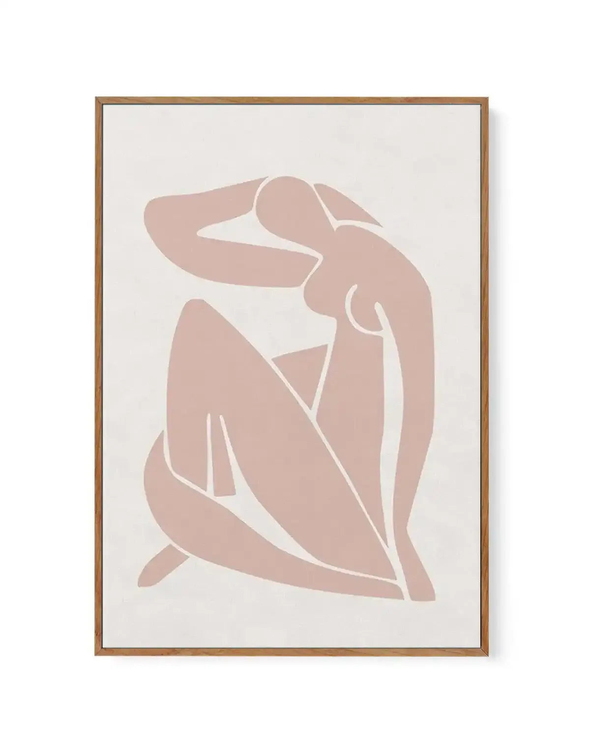 Framed canvas art print featuring an abstract female figure in minimalist style. The figure is rendered in soft dusty rose tones against a cream background, with white line work outlining the body's contours. The seated or crouching pose shows simplified, flowing forms suggesting the head, torso, arms, and legs. The design uses negative space and curved lines to create an elegant, contemporary aesthetic. Natural wood-toned frame with white border surrounding the canvas.