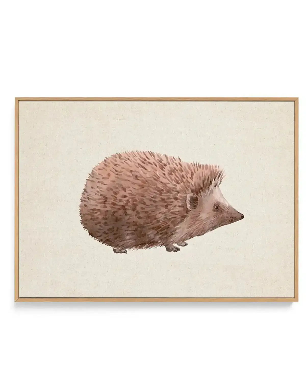 Framed canvas art print featuring a watercolor illustration of a hedgehog in profile facing left. The hedgehog has soft, textured quills rendered in warm taupe and dusty rose tones with fine detail work. Its small eye, ear, and delicate snout are rendered in muted brown. The background is a soft cream linen canvas. The artwork is presented in a natural wood frame with a thin border.