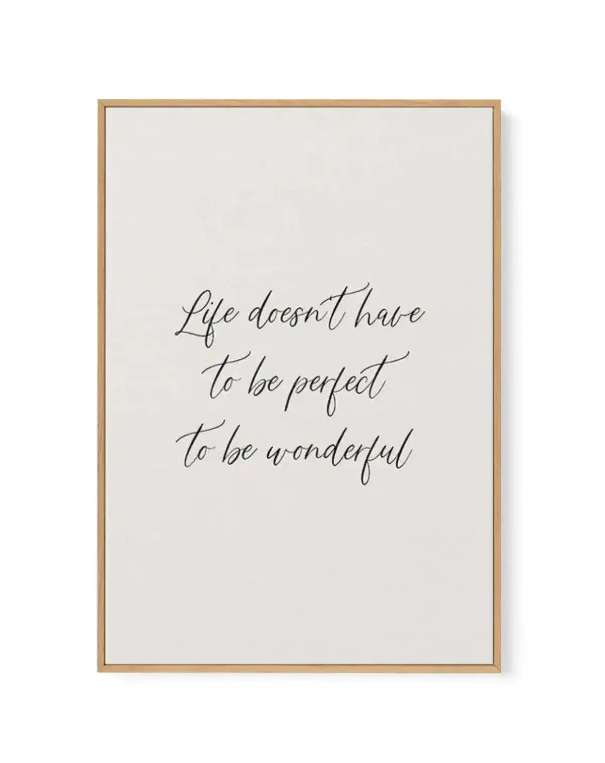 Framed canvas art print with a natural wood frame displaying handwritten script text in dark gray that reads "Life doesn't have to be perfect to be wonderful" centered on a cream-colored background with white border. The text uses a flowing, cursive calligraphy style. The wood frame has a light tan finish with visible grain texture.