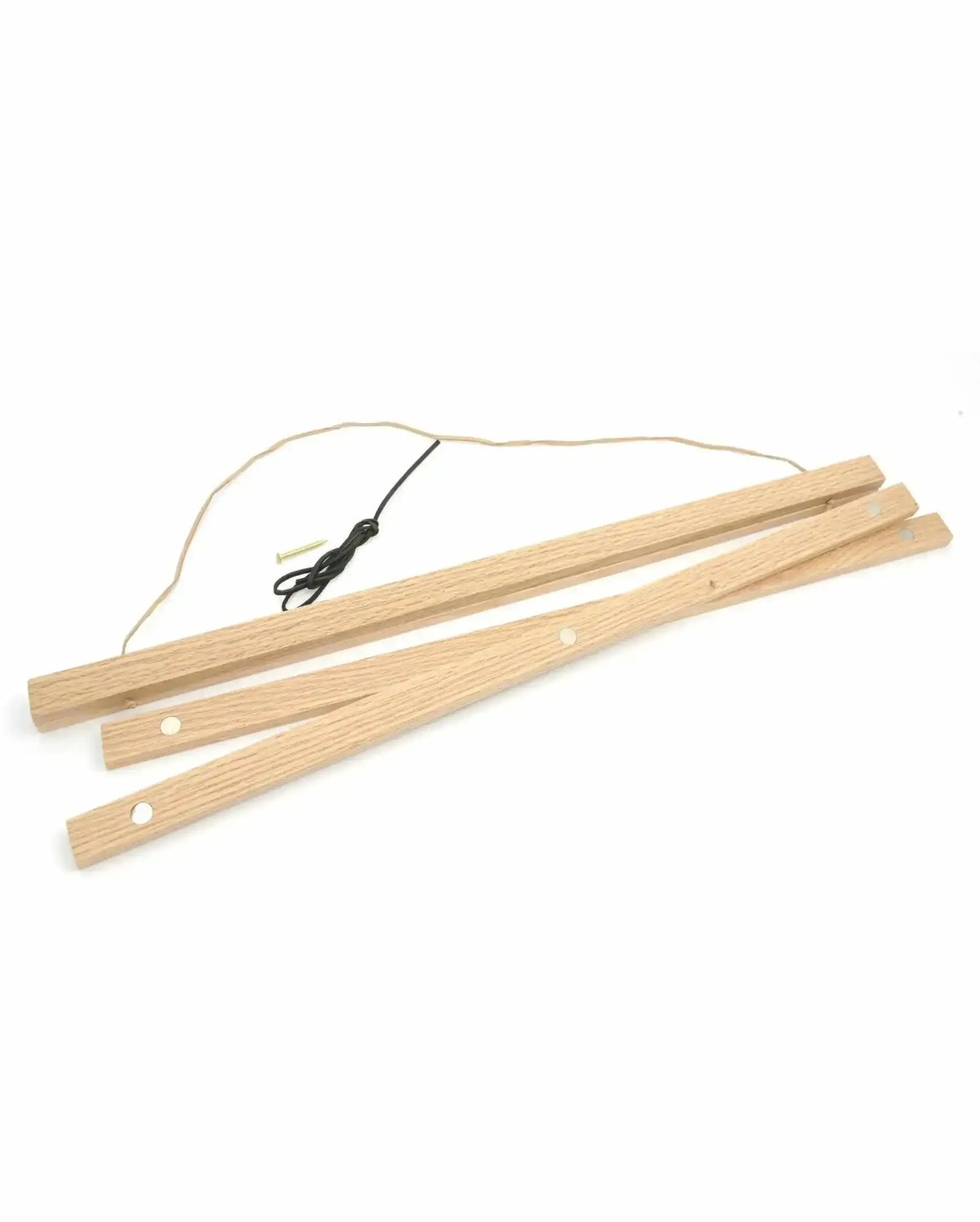 Oak wood poster hanger with natural light wood finish, consisting of three wooden slats with small circular holes for hanging. Black cord with metal connectors attached to the top slat. The hanger is displayed at an angle against a white background, showing the natural wood grain texture and warm honey-toned finish. Designed to suspend art prints or posters.