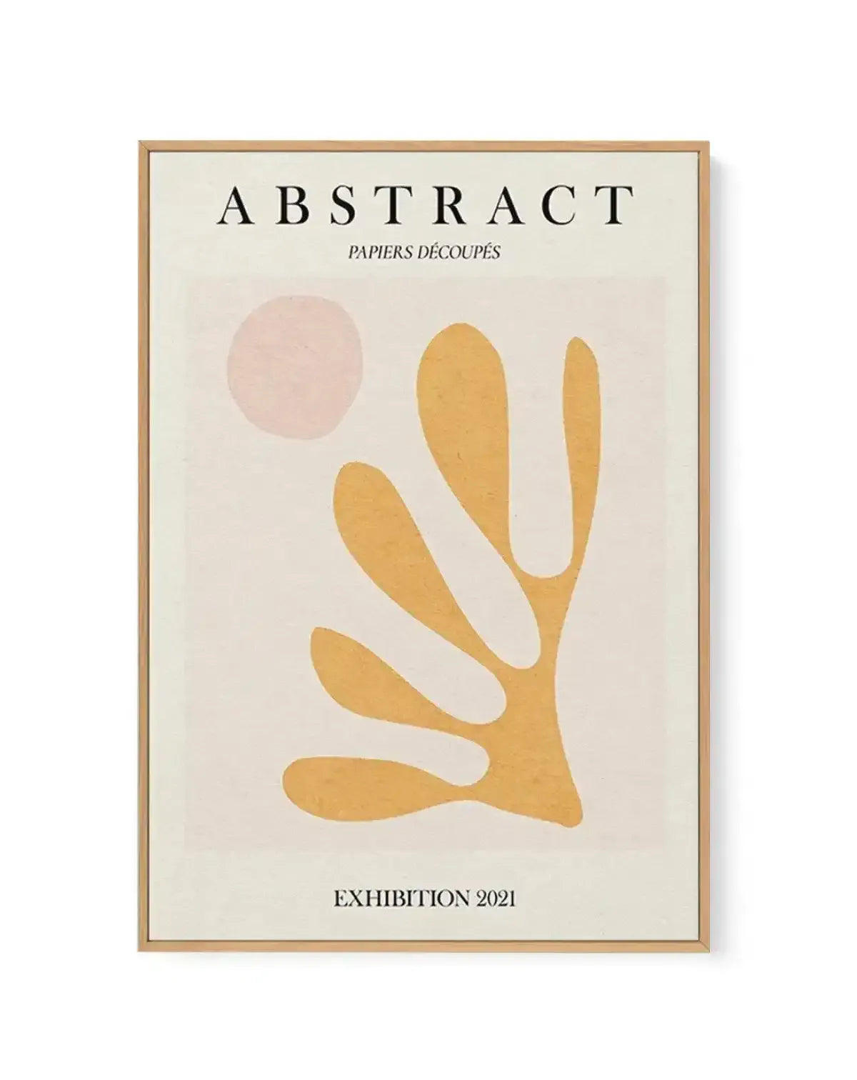 Framed canvas art print titled "Abstract Papiers Découpés Exhibition 2021" featuring minimalist cut-paper style artwork. Design shows a golden-yellow organic hand-like or plant form with elongated curved fingers against a pale cream background, with a soft dusty rose circular shape in the upper left. Natural wood frame with white border. Text at top reads "ABSTRACT" with subtitle "PAPIERS DÉCOUPÉS" and exhibition date at bottom. Flat, matte finish with warm, earthy aesthetic.