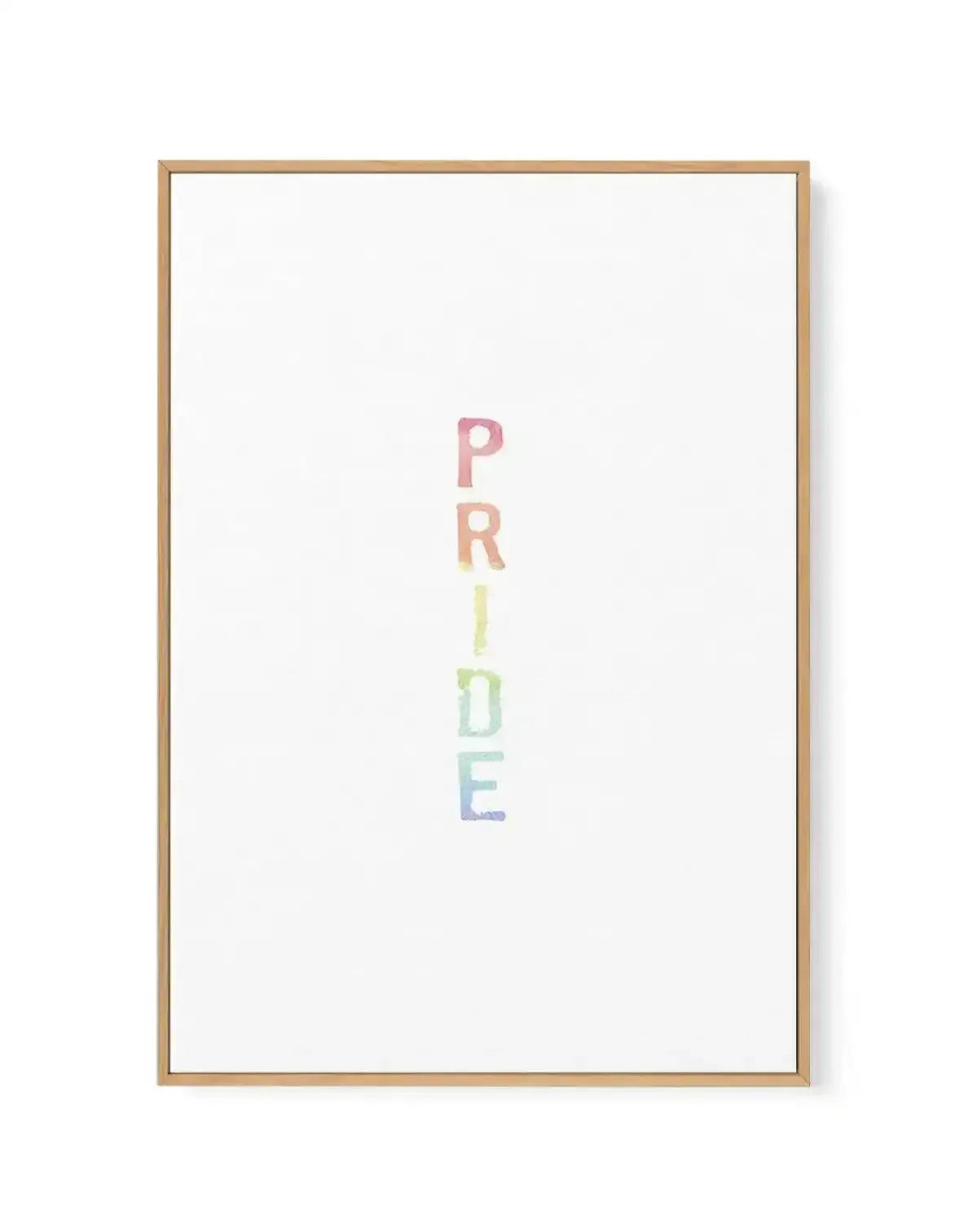 Framed canvas art print featuring the word "PRIDE" written vertically in center composition. Each letter is rendered in watercolour with a gradient rainbow effect, transitioning from pink at top through coral, yellow, green, to blue at bottom. White background with natural wood frame and thin wooden border visible around edges.