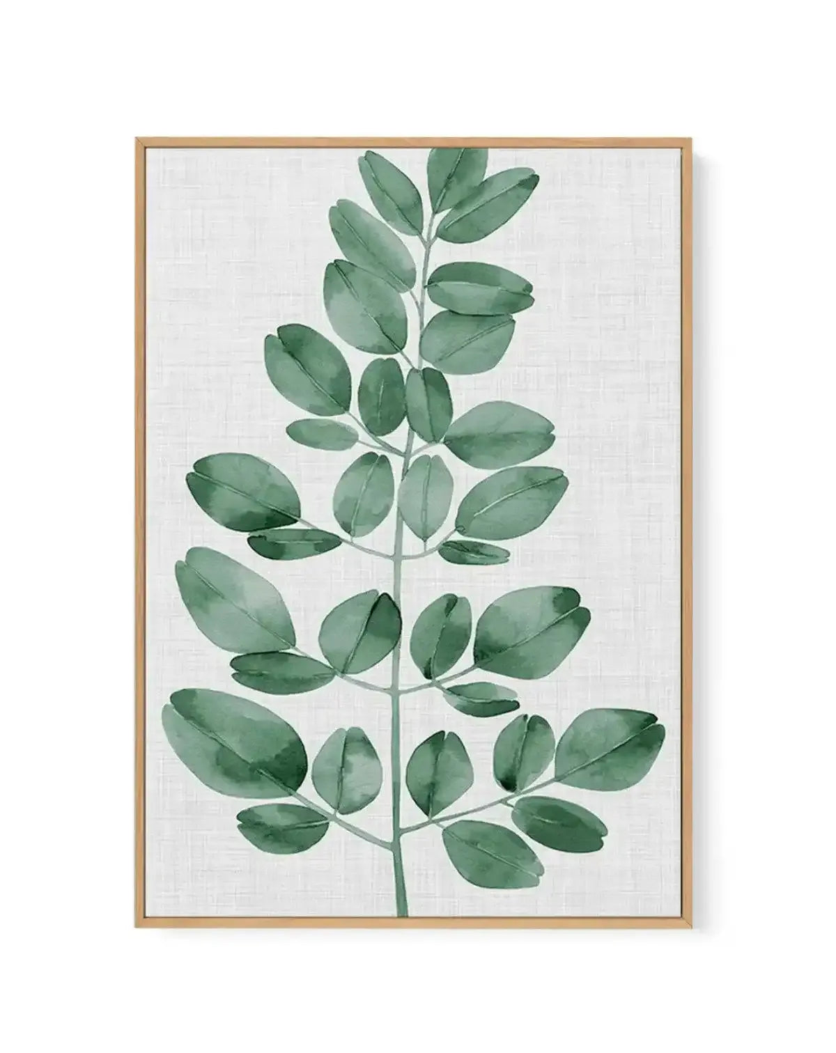 Framed canvas art print featuring a watercolor illustration of a single green botanical stem with oval-shaped leaves arranged alternately along a thin central stem. The leaves display varying shades of sage green and muted forest green with visible brushstroke texture and subtle veining details. The composition is centered vertically on a light cream linen-textured background. The artwork is set in a natural wood frame with a white border.