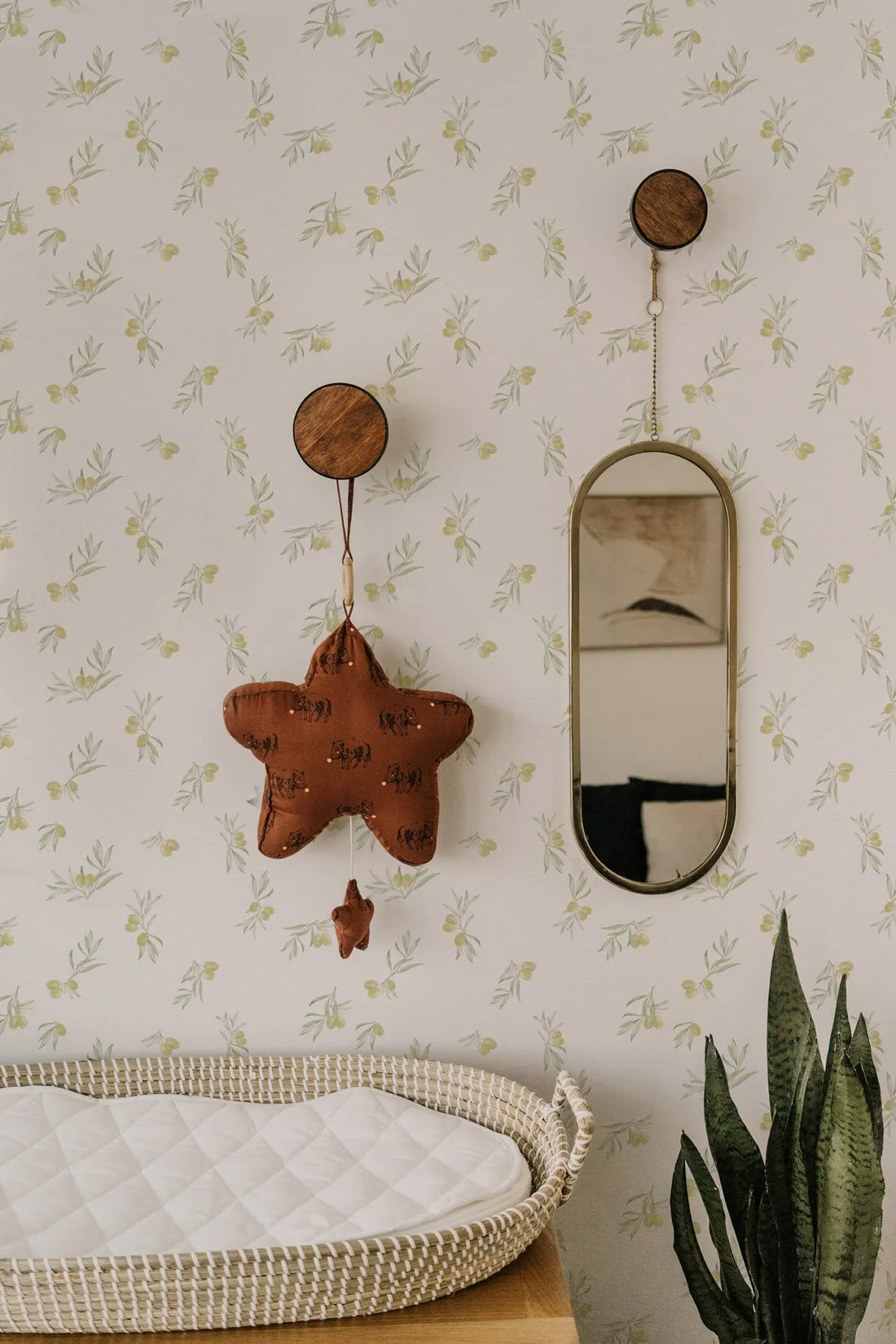 Petite Olive Branch Wallpaper styled in a classic nursery with delicate olive sprigs on a cream ground