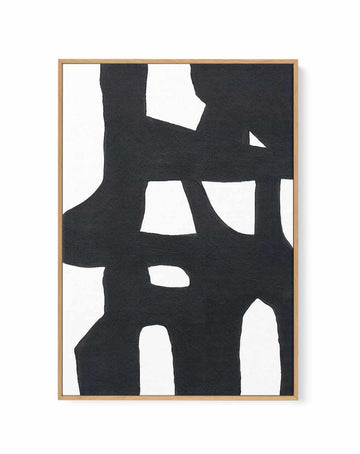 Bold black and white abstract print with interlocking organic shapes, in a natural wood frame