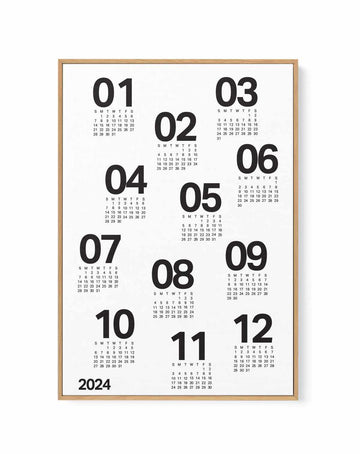 White 12-month scatter calendar poster with bold black numerals, in a natural wood frame