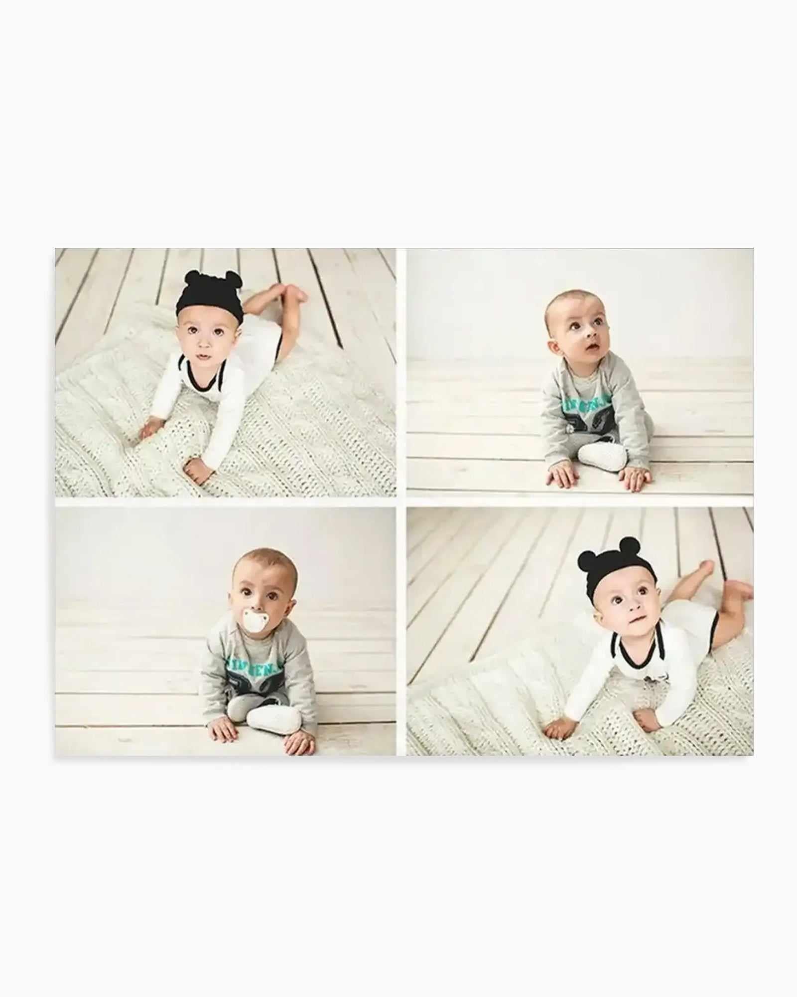 Art print featuring four square photographs of a baby, arranged in a 2x2 grid. The baby is wearing different outfits, including a white long-sleeved onesie with a black trim and a black hat with two round ears, and a grey long-sleeved onesie. In some photos, the baby is on a white textured blanket, and in others, on a white wooden floor. The baby is looking up or directly at the camera, and in one photo, has a white pacifier in their mouth.