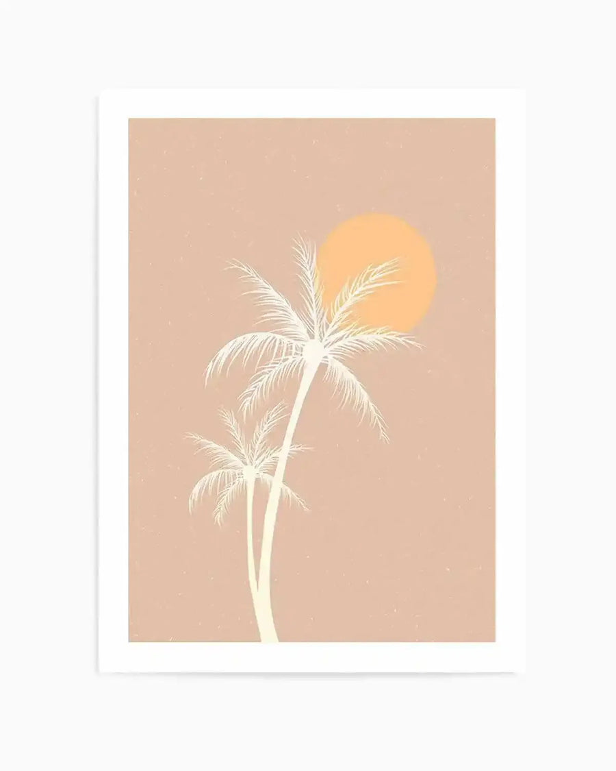 Art print featuring a minimalist illustration of two palm trees in a pale cream silhouette against a warm, dusty rose background with a large, soft orange sun in the upper right. The print has a subtle textured finish, reminiscent of a vintage screen print.