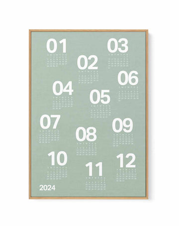 Sage green 12-month calendar poster with bold white numerals on textured background, in a natural wood frame