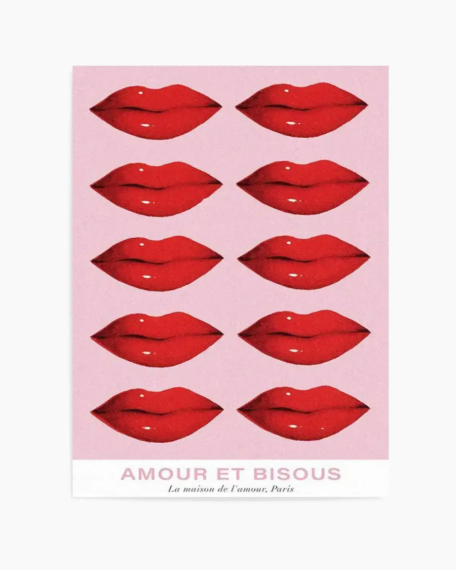 Art print featuring ten pairs of bright red lips with subtle highlights, arranged in five rows of two on a soft pink background. The print includes the text "AMOUR ET BISOUS" in light pink capital letters, with "La maison de l'amour, Paris" in smaller text below.