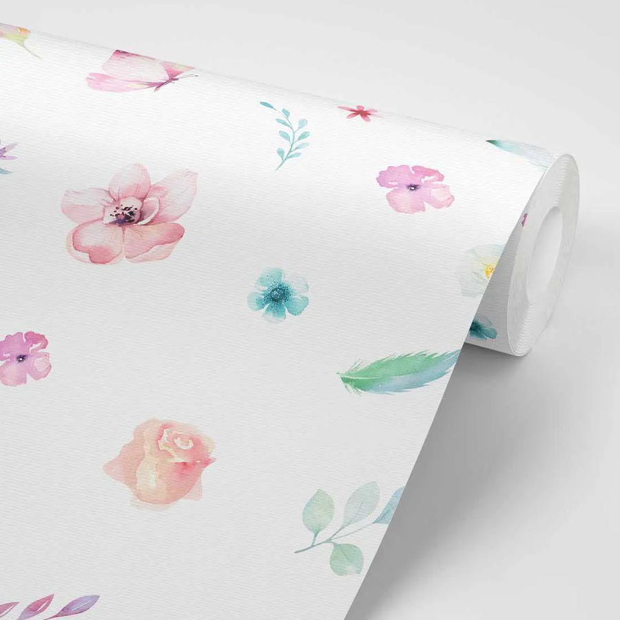 Peel and stick wallpaper featuring a repeating pattern of delicate watercolour illustrations of flowers, butterflies, and leaves in soft pastel shades of pink, blue, green, and purple on a white background. The wallpaper is shown partially unrolled, revealing the textured surface and the continuous, scattered design.