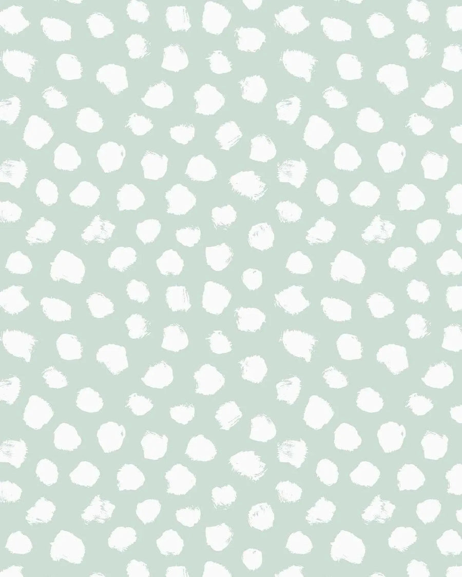Bella's Dots Modern Mint Wallpaper features a repeating pattern of white hand-painted circular and organic brush stroke dots scattered across a soft sage green background. The dots vary in size and shape, some perfectly round and others with irregular, textured edges suggesting watercolor or acrylic paint application. The composition is evenly distributed across the surface, creating a calm, minimalist aesthetic with a contemporary feel.