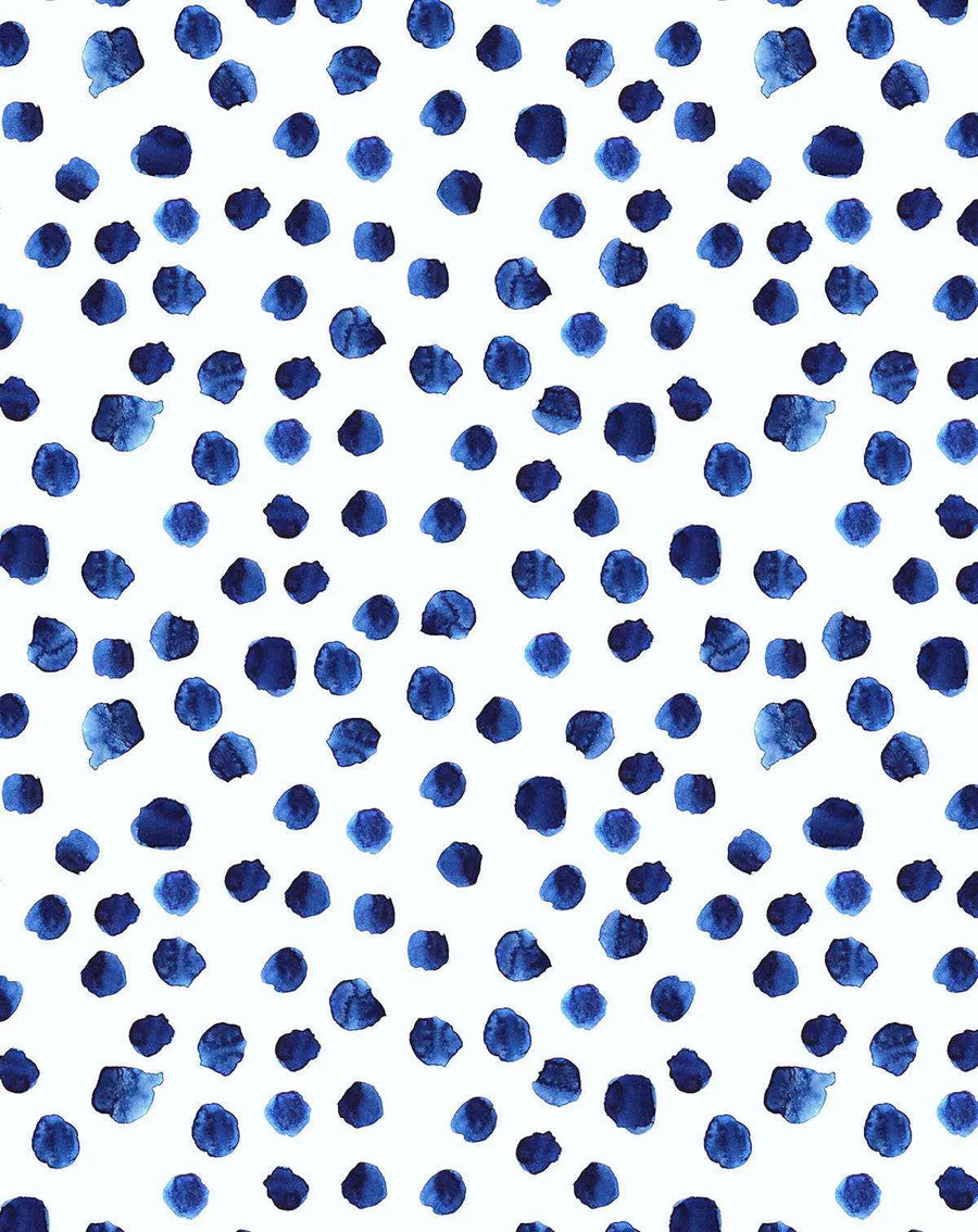 Peel and stick wallpaper featuring a repeating pattern of hand-painted dots in varying shades of deep indigo and cobalt blue on a clean white background. The watercolour design has a loose, organic quality with visible brushstroke texture and subtle colour variations within each dot.