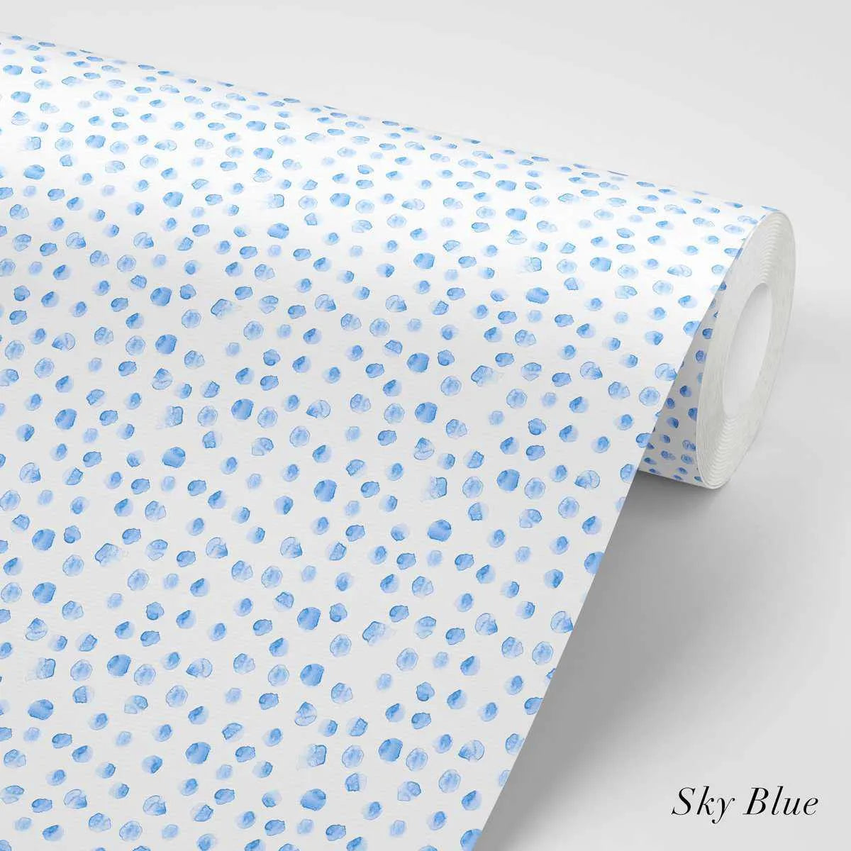 Peel and stick wallpaper featuring a repeating pattern of small, irregular, hand-painted dots in sky blue on a white background. The dots have a loose, organic watercolor quality with visible brushstroke texture.