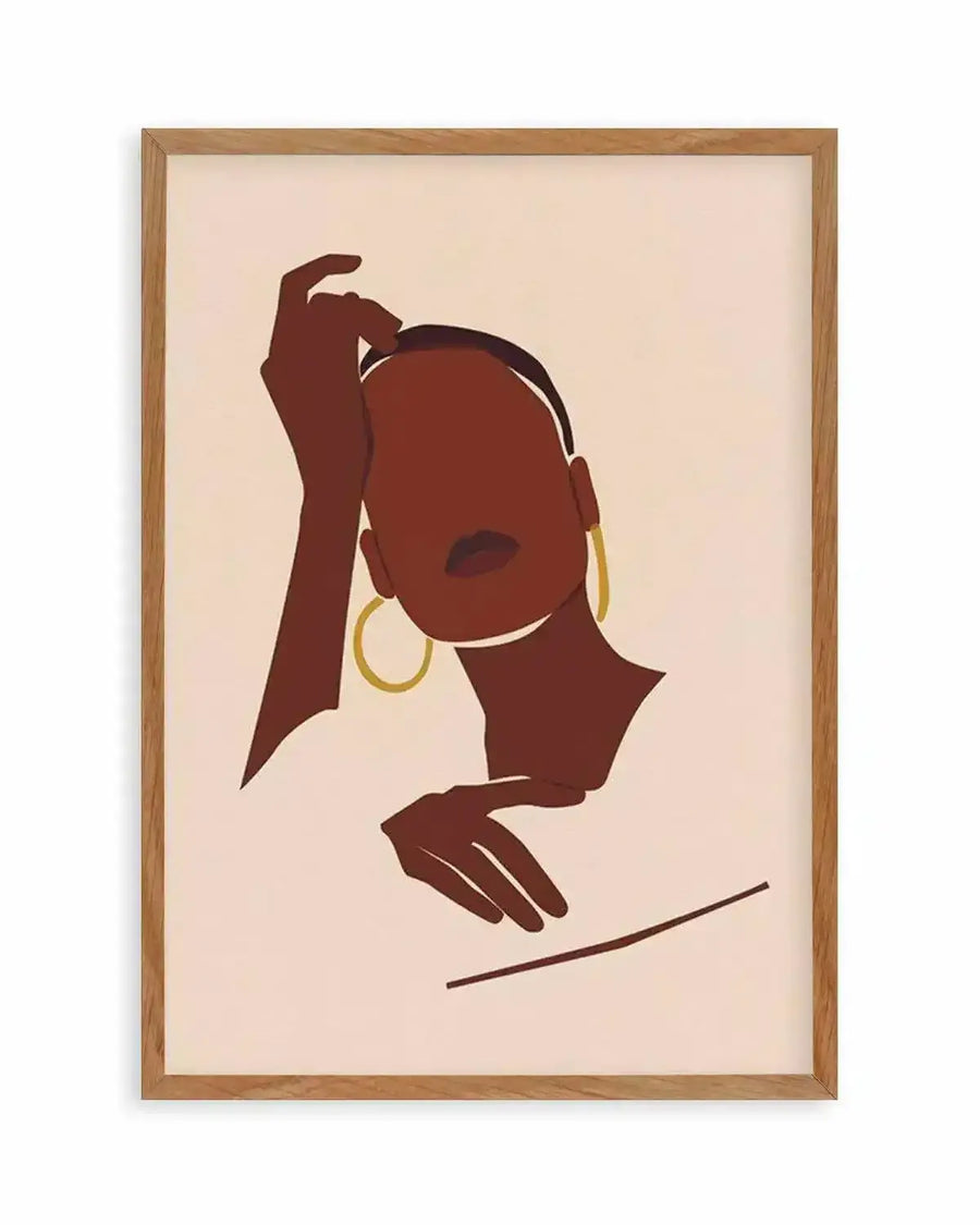 Art print featuring a minimalist illustration of a woman with dark brown skin, short dark hair, and golden hoop earrings, displayed in a natural oak frame with white border. Her face is turned slightly to the left, with her right hand gently touching her head and her left hand resting below. Her lips are a deep red, and the background is a soft cream colour.