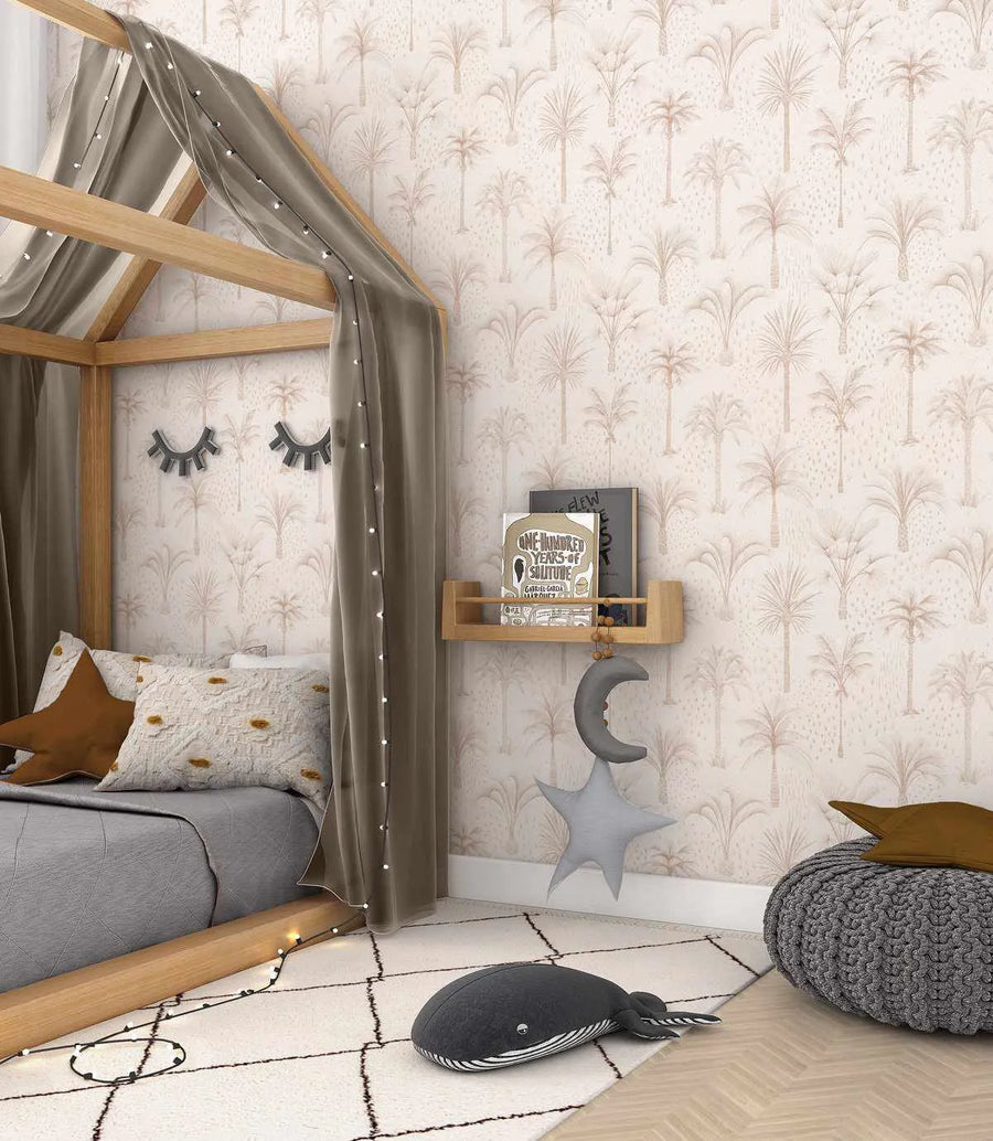 Nursery:
"Bohemian Palms wallpaper featuring a repeating pattern of hand-drawn palm trees in a muted beige on a cream background, displayed on the wall of a child's bedroom. The room includes a wooden house-frame bed with grey bedding, a brown star pillow, and a white textured pillow with yellow floral accents. A wooden shelf holds books, and a grey moon and star plush hang below. A grey knitted pouf and a whale plush sit on a white rug with black diamond patterns."