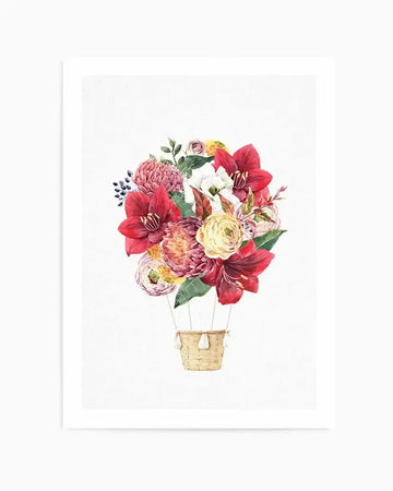 Watercolour art print featuring a hot air balloon with a basket woven from light brown wicker, carrying a vibrant bouquet of flowers as its balloon. The bouquet includes large red amaryllis, white and yellow ranunculus, pink protea, and small blue berries, all with visible brushstroke texture on a white background.