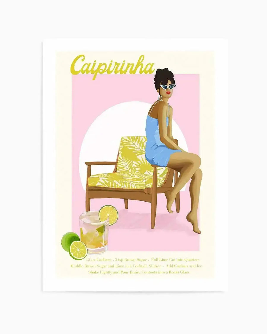 Art print featuring a retro-style illustration of a woman in a light blue dress and white sunglasses sitting on a yellow and green patterned chair, with a Caipirinha cocktail and limes in the foreground. The background is a soft pink rectangle with a white circle behind the woman, and the title "Caipirinha" in yellow script at the top.