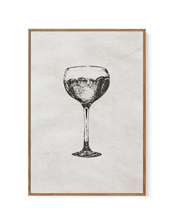 Black and white line drawing of a cocktail glass filled with bubbling liquid, centered on a cream-colored textured background. The glass features a wide bowl top and slender stem with detailed cross-hatching showing dimension and reflection. Framed in natural wood-toned frame with white border.
