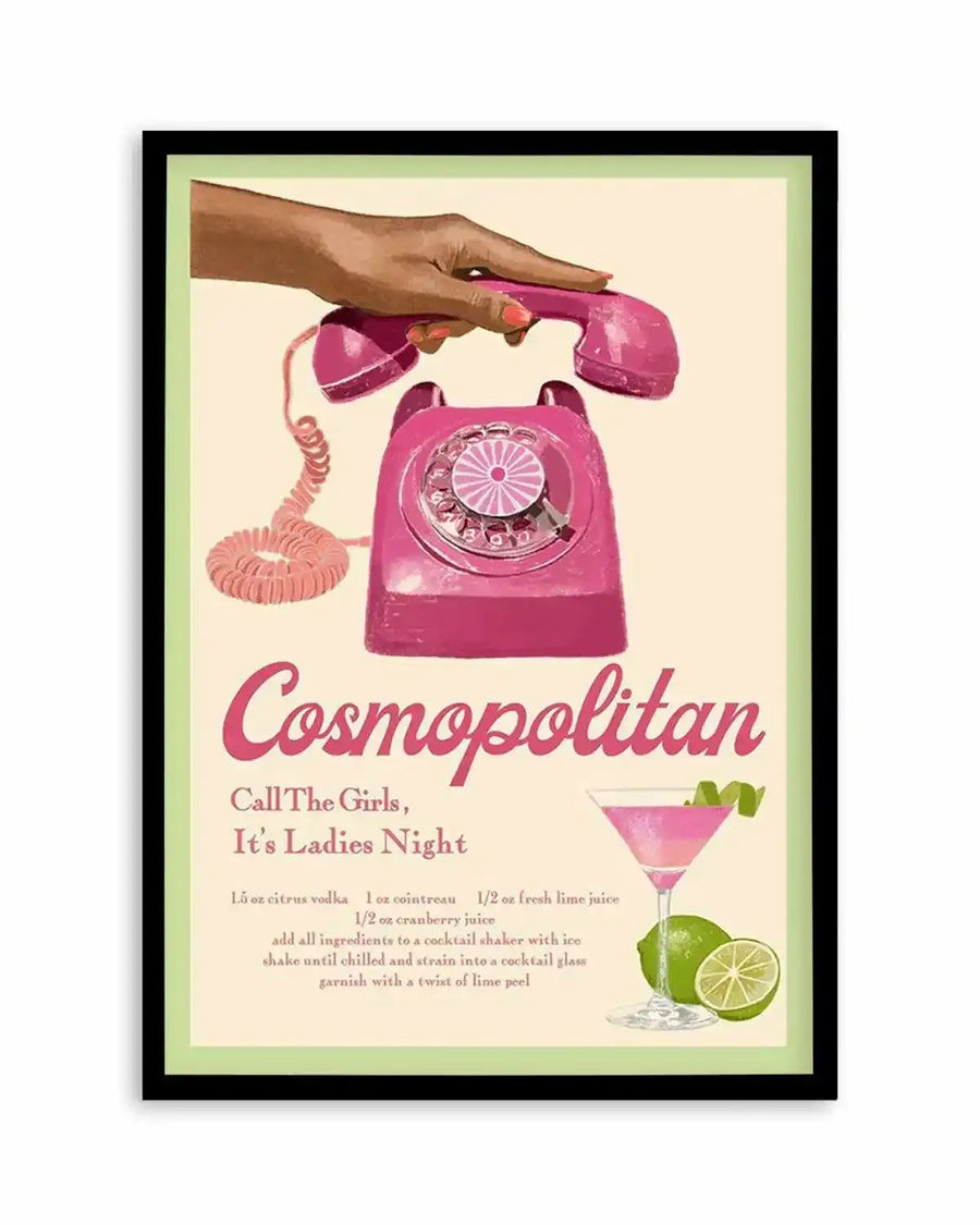Retro-style art print featuring a vibrant pink rotary telephone with a dark-skinned hand holding the receiver, set against a pale cream background. The print includes the text "Cosmopolitan," "Call The Girls, It's Ladies Night," and a recipe for the cocktail, alongside an illustration of a pink cosmopolitan drink with a lime twist and two whole limes. The print is displayed in a black frame with a white border.
