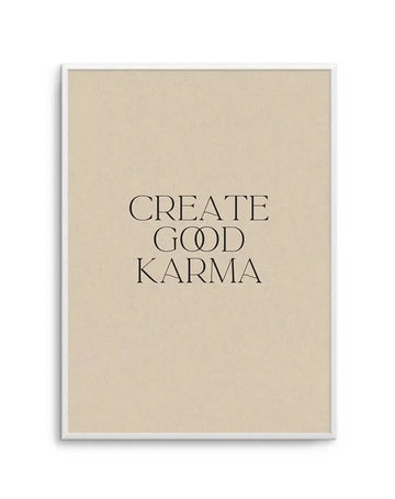 Art print featuring the words "CREATE GOOD KARMA" in a classic serif font with a unique double-lined "OO" in "GOOD", printed in black on a warm beige background and displayed in a white frame with a white border.