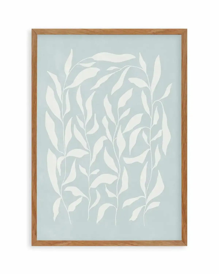 Art print featuring an illustration of several tall, slender plant stems with numerous elongated, white leaves on a soft, pale blue background, displayed in a natural oak frame with white border.