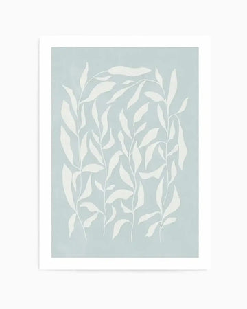 Art print featuring an illustration of several tall, slender plant stems with numerous elongated, oval-shaped leaves in a soft, muted white against a pale, dusty blue background. The composition shows the stems arranged vertically, with some leaves curving and overlapping, creating a gentle, organic pattern. The print is displayed with a clean white border.
