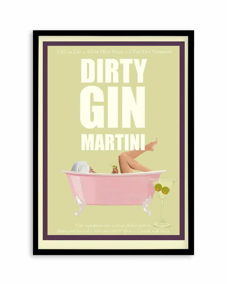 Framed art print featuring a vintage-style illustration of a woman relaxing in a pink bathtub against a pale yellow background. Large white text reads "DIRTY GIN MARTINI" with cocktail recipe ingredients at top. A martini glass with green olives sits beside the tub. Instructions for preparation appear at bottom in small text. The artwork is surrounded by a cream-colored border and framed in dark wood with black outer frame.