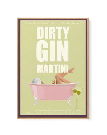 Framed canvas print featuring a retro-style illustration of a woman relaxing in a pink bathtub, holding a cocktail, with a martini glass with olives in the foreground, all on a pale lime green background. The text "DIRTY GIN MARTINI" is prominently displayed in large white letters, with ingredients and instructions in smaller text. The print is displayed in a light brown wooden frame with a dark brown inner border.