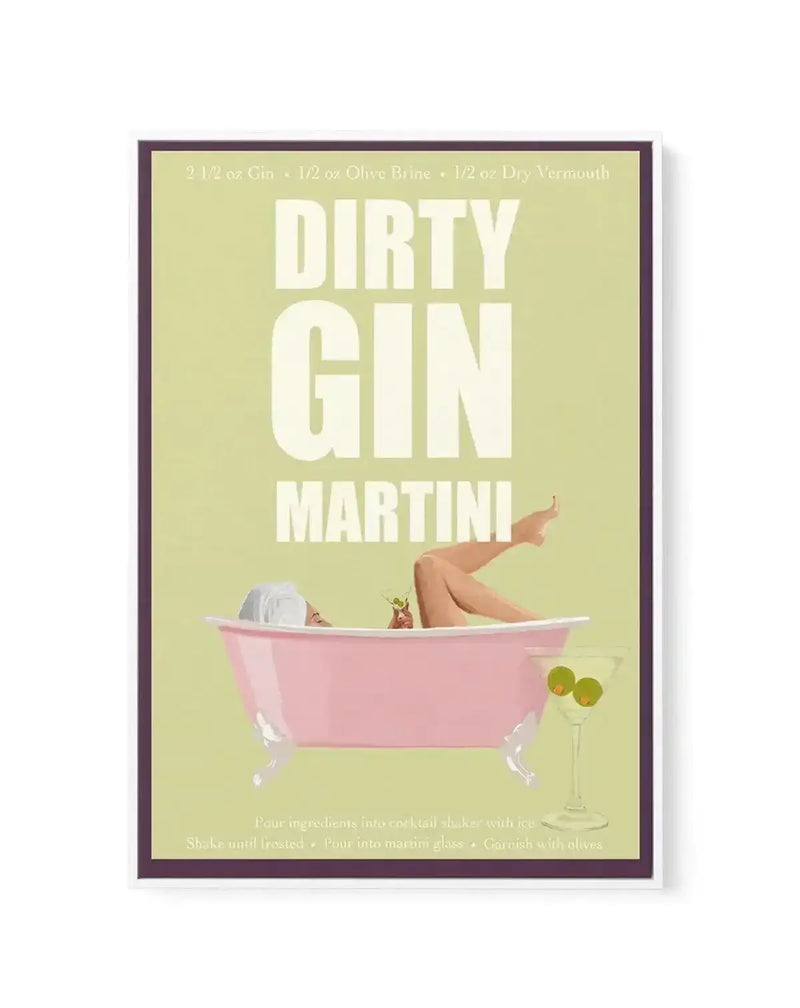 Framed canvas art print featuring a retro-style illustration of a woman relaxing in a pink bathtub, holding a cocktail. The background is a soft lime green, with text in white reading "DIRTY GIN MARTINI". A martini glass with two olives sits in the foreground.