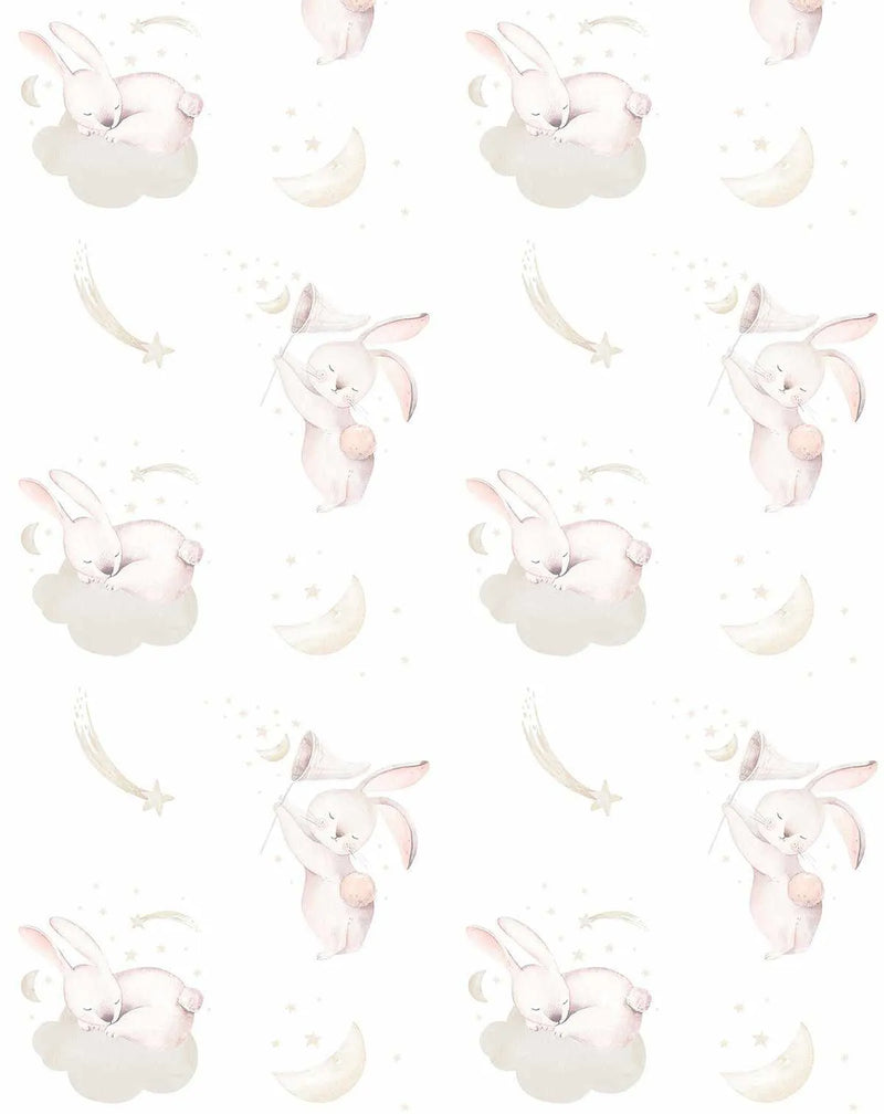 Peel and stick wallpaper featuring a repeating pattern of hand-painted sleeping and playing bunnies in soft blush pink and cream tones on a white background. The design includes bunnies sleeping on fluffy cream clouds, bunnies holding star-catching nets, crescent moons, and shooting stars, all with a gentle watercolour texture.