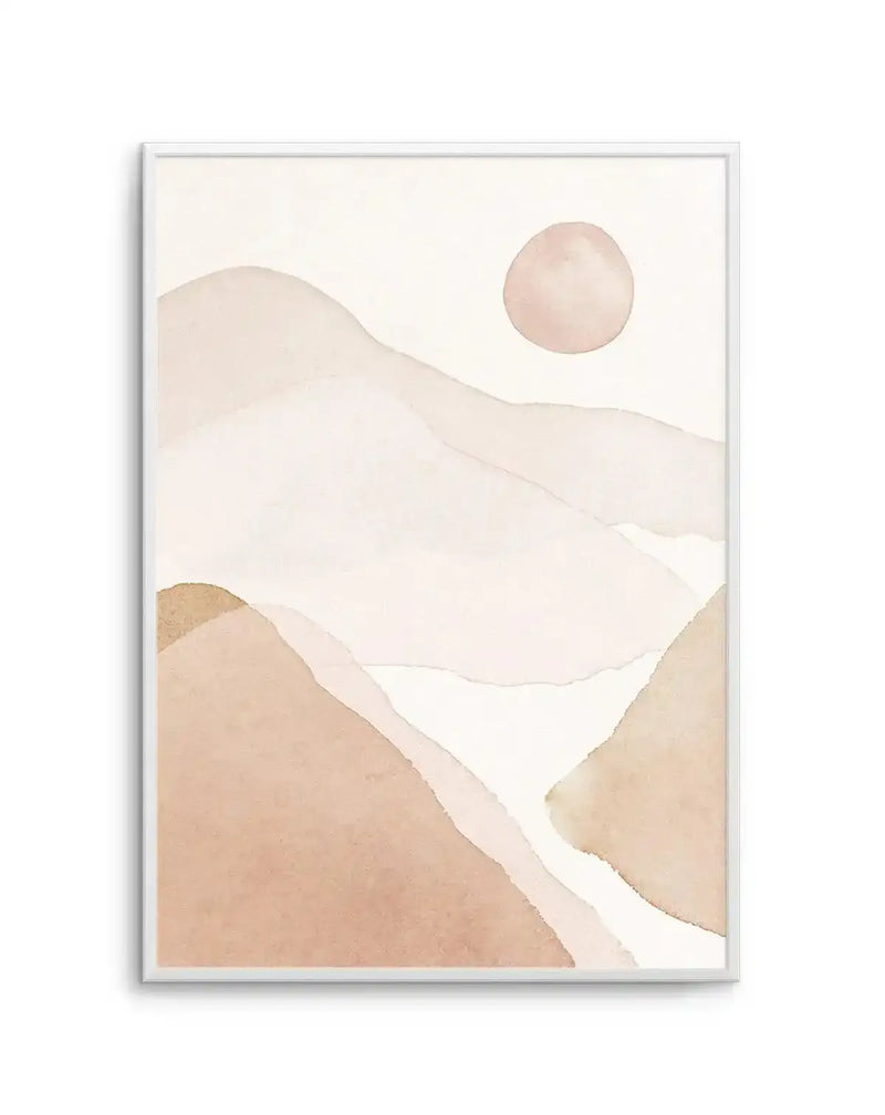 Abstract art print featuring a minimalist watercolour landscape with rolling hills and mountains in varying shades of dusty rose, pale peach, and warm cream, with a soft pink sun in the upper right, printed on fine art paper and displayed in a white frame with white border.