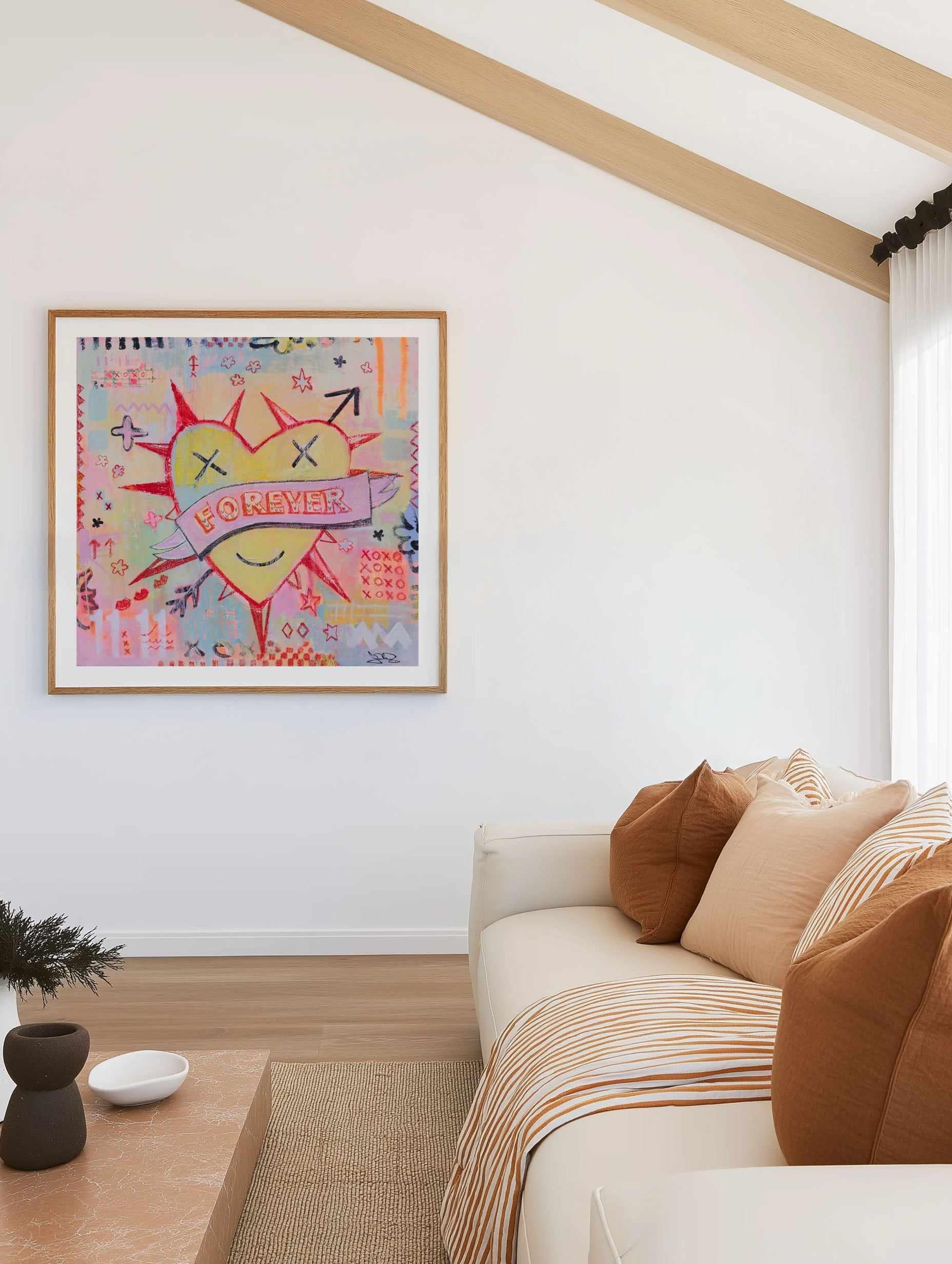 Colorful Jackie Green abstract painting on a wall above a sofa with pillows in a living room.