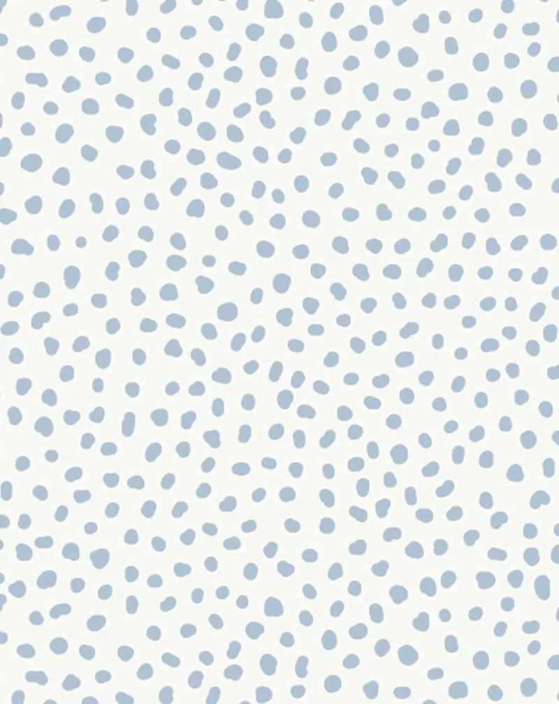 Gigi's Dots Wallpaper in Barely Blue features a repeating pattern of hand-painted, organic dots in soft slate blue scattered across a cream-white background. The dots vary in size from small to medium and are irregularly shaped with soft, slightly fuzzy edges, creating a watercolor effect. The pattern has an all-over, non-directional layout that maintains consistent density throughout the design, giving it a calm, scattered aesthetic.