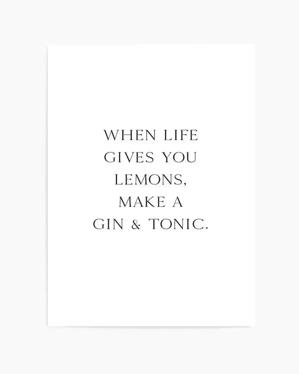 Art print on white background featuring centered black serif typography reading "WHEN LIFE GIVES YOU LEMONS, MAKE A GIN & TONIC." The text is evenly spaced across the cream-colored paper in a classic, minimalist design with generous white space surrounding the quote.