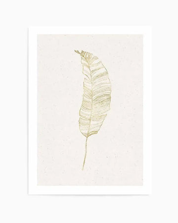 Art print featuring a single, elongated palm leaf illustration in shimmering gold against a textured, speckled cream background. The leaf has a delicate, hand-drawn quality with fine lines detailing its veins and slightly ruffled edges.