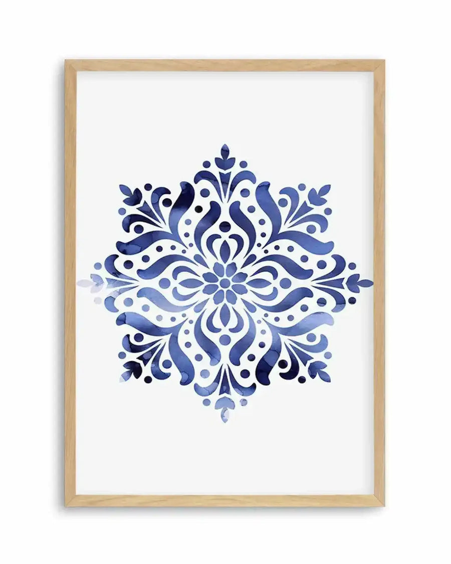 Watercolour art print featuring a symmetrical mandala-like design in varying shades of deep and light blue, with intricate floral and swirling patterns, printed on fine art paper and displayed in a natural oak frame with white border.