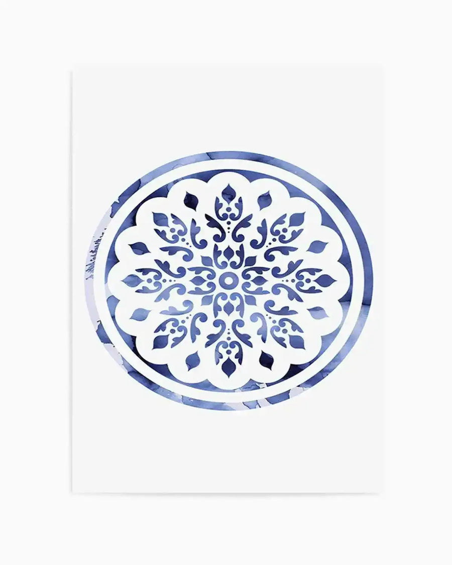 Watercolour art print featuring a circular mandala design with intricate floral and scrollwork patterns in varying shades of blue, from deep navy to pale sky blue, against a white background. The blue areas have a soft, marbled watercolour texture, while the white areas form the detailed cut-out patterns.