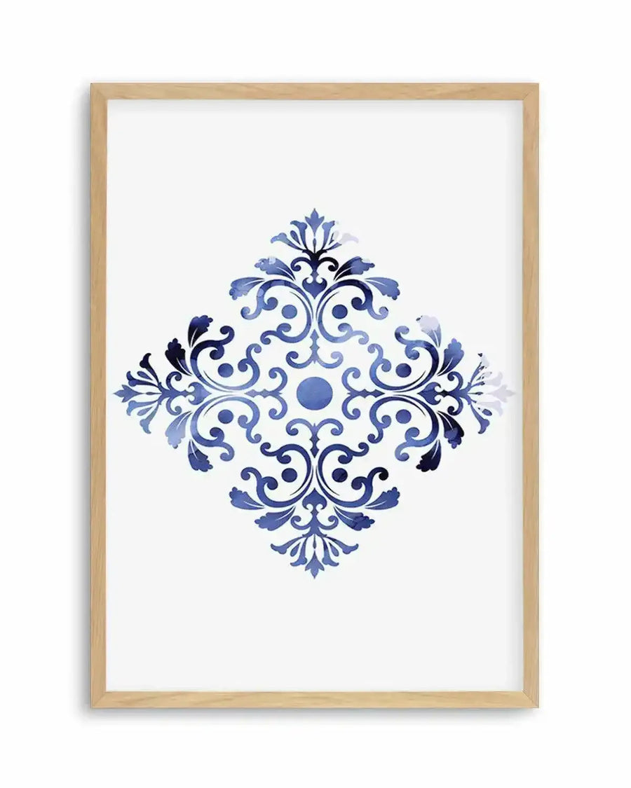 Watercolour art print featuring a symmetrical, diamond-shaped ornate pattern in varying shades of blue, from deep navy to light sky blue, on a white background, printed on fine art paper and displayed in a natural oak frame with white border.